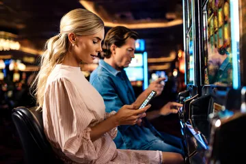A cheerful woman in traditional clothing using her smartphone during a festive moment, showing how easily the GB44 app fits into everyday life.