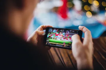 A professional dealer in a tuxedo greeting players at the roulette table, symbolizing the authentic live casino feel at GB44.