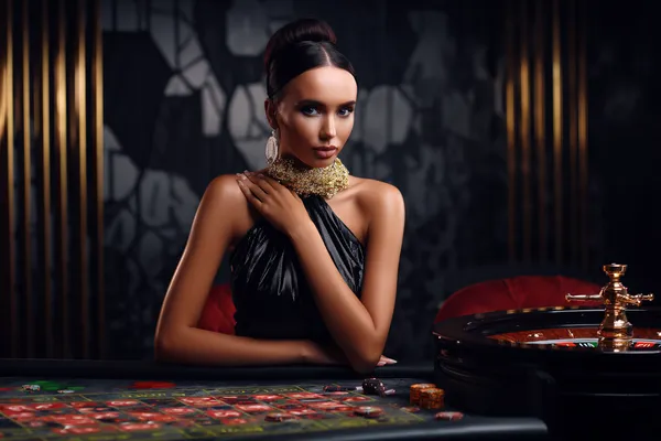 A stylish woman beside vibrant slot machines displaying glowing sevens, showcasing the variety of top slots at GB44.